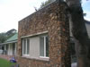Drystone appearance basalt feature wall with polished concrete coping and sills