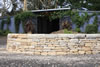 Drystone split Bundanoon sandstone retaining wall with large sandstone coping